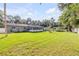 Large backyard featuring a screened-in porch, a storage shed and pergola at 1144 Corbin Park Rd, New Smyrna Beach, FL 32168