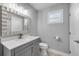 Updated bathroom featuring tile floors, new fixtures, large mirror, and a modern vanity at 1144 Corbin Park Rd, New Smyrna Beach, FL 32168