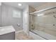 Bathroom with tiled shower and glass doors, updated vanity, lighting and fixtures at 1144 Corbin Park Rd, New Smyrna Beach, FL 32168