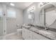 Bright bathroom with double sinks, granite countertops, modern fixtures, and natural lighting at 1144 Corbin Park Rd, New Smyrna Beach, FL 32168