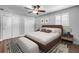 Comfortable bedroom featuring a ceiling fan, wood floors, and double closets for ample storage space at 1144 Corbin Park Rd, New Smyrna Beach, FL 32168