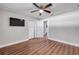 Bedroom featuring laminate floors, neutral walls, a ceiling fan, and two closets with white doors at 1144 Corbin Park Rd, New Smyrna Beach, FL 32168
