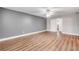 Spacious bedroom featuring laminate wood flooring, a ceiling fan, and neutral paint at 1144 Corbin Park Rd, New Smyrna Beach, FL 32168