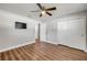 Spacious bedroom features wood-look floors, a ceiling fan, TV and two closets for storage at 1144 Corbin Park Rd, New Smyrna Beach, FL 32168