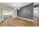 Dining area with wood floors, sliding glass doors, and a gray accent wall at 1144 Corbin Park Rd, New Smyrna Beach, FL 32168