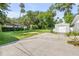 Long driveway with storage shed, offering ample parking and storage space at 1144 Corbin Park Rd, New Smyrna Beach, FL 32168