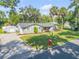 Charming single-story home with well-manicured lawn, palm trees, and a detached shed at 1144 Corbin Park Rd, New Smyrna Beach, FL 32168