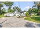 Home exterior featuring a driveway, shed, and well-manicured landscaping at 1144 Corbin Park Rd, New Smyrna Beach, FL 32168