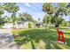 Beautiful home with well-kept lawn, storage shed, and red front door at 1144 Corbin Park Rd, New Smyrna Beach, FL 32168