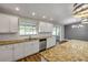 A sunny kitchen featuring a breakfast bar, stainless appliances, granite countertops, and outdoor access at 1144 Corbin Park Rd, New Smyrna Beach, FL 32168