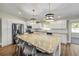 Well-lit kitchen with a granite island, stainless steel appliances, and ample counter space at 1144 Corbin Park Rd, New Smyrna Beach, FL 32168