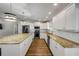This kitchen features stainless appliances, granite countertops, and white cabinets and a central island at 1144 Corbin Park Rd, New Smyrna Beach, FL 32168