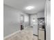 Laundry room featuring tile floors, a washer, shelving, and two doorways at 1144 Corbin Park Rd, New Smyrna Beach, FL 32168