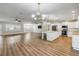 Open-concept living area featuring wood floors, recessed lighting, and a kitchen with a large island at 1144 Corbin Park Rd, New Smyrna Beach, FL 32168