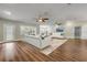 Bright living room featuring hardwood floors, stylish white sofas, plantation shutters and ample natural light at 1144 Corbin Park Rd, New Smyrna Beach, FL 32168