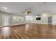 Spacious living room featuring wood floors, two ceiling fans, and windows with wood shutter blinds at 1144 Corbin Park Rd, New Smyrna Beach, FL 32168