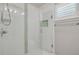 The bathroom has a walk-in shower with white subway tile and a glass door at 1144 Corbin Park Rd, New Smyrna Beach, FL 32168