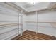Walk-in closet complete with built-in shelving and wood laminate flooring at 1144 Corbin Park Rd, New Smyrna Beach, FL 32168