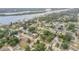 Aerial view of neighborhood surrounded by lush trees, waterways, and local roads at 125 Orange Ave, Edgewater, FL 32132