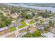 Aerial view of a neighborhood with houses, green trees, a bay, and a blue waterway at 125 Orange Ave, Edgewater, FL 32132