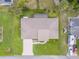 Aerial view of a well-maintained home with lush lawn, mature trees and RV parking at 125 Orange Ave, Edgewater, FL 32132
