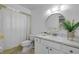 Bathroom with shower/tub combo with a curtain, a vanity with a sink and a large mirror at 125 Orange Ave, Edgewater, FL 32132