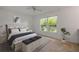 Bright bedroom featuring a large window, a decorative plant, and a king-sized bed at 125 Orange Ave, Edgewater, FL 32132