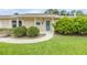 Close-up of the home's front entrance with a well-maintained lawn and landscaping at 125 Orange Ave, Edgewater, FL 32132