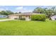 Welcoming ranch style home with lush green lawn and manicured landscaping at 125 Orange Ave, Edgewater, FL 32132