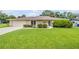 Charming one-story brick home with a well-manicured lawn and inviting curb appeal at 125 Orange Ave, Edgewater, FL 32132