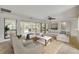 Bright living room featuring neutral tones, comfortable seating, and sliding glass doors to the outdoor space at 125 Orange Ave, Edgewater, FL 32132