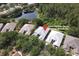 Aerial view of home on a wooded lot with mature landscaping and nearby pond at 1442 Carlow Cir, Ormond Beach, FL 32174