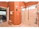 This spacious bathroom features an enclosed tiled shower, towel racks and an adjoined bedroom suite at 1442 Carlow Cir, Ormond Beach, FL 32174