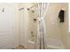 Well-lit bathroom featuring a shower with a curtain, a storage closet, and a full bathtub at 1442 Carlow Cir, Ormond Beach, FL 32174