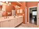Well-lit bathroom featuring a double vanity, neutral color scheme, and tiled floors at 1442 Carlow Cir, Ormond Beach, FL 32174