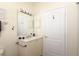 Bright bathroom with white vanity, framed mirror, and a door to the toilet and shower at 1442 Carlow Cir, Ormond Beach, FL 32174