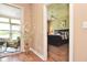 Open doorway view of a primary bedroom suite and sunroom featuring hardwood floors and a ceiling fan at 1442 Carlow Cir, Ormond Beach, FL 32174