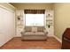 Bonus room featuring hardwood floors, a comfy couch, a bright window, and built-in shelving at 1442 Carlow Cir, Ormond Beach, FL 32174