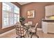 Bright breakfast nook with round glass table and four chairs beside window with plantation shutters at 1442 Carlow Cir, Ormond Beach, FL 32174