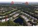 Community aerial view with homes near ponds, golf courses, shopping, beaches, and state parks at 1442 Carlow Cir, Ormond Beach, FL 32174