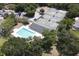 Aerial view of pool and tennis courts surrounded by lush greenery at 1442 Carlow Cir, Ormond Beach, FL 32174