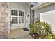 Welcoming entryway with stone accents, decorative plants, and a charming front door at 1442 Carlow Cir, Ormond Beach, FL 32174