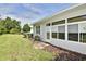 Exterior view of home with a private backyard, Florida room, and well-maintained lawn at 1442 Carlow Cir, Ormond Beach, FL 32174