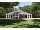 White gazebo with green roof surrounded by trees and lush lawn at 1442 Carlow Cir, Ormond Beach, FL 32174
