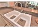 The kitchen features a double basin sink with a modern faucet and a neutral-toned countertop at 1442 Carlow Cir, Ormond Beach, FL 32174