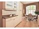 Kitchen nook featuring white cabinets, white appliances, and decorative accents at 1442 Carlow Cir, Ormond Beach, FL 32174