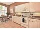 Bright kitchen with white cabinets, tiled floor, and an adjacent breakfast nook area at 1442 Carlow Cir, Ormond Beach, FL 32174