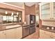 A spacious kitchen featuring a sink, stainless steel appliances, and white cabinetry with glass fronts at 1442 Carlow Cir, Ormond Beach, FL 32174