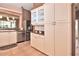 This kitchen showcases stainless steel appliances, tiled floors, and white cabinets for plenty of storage at 1442 Carlow Cir, Ormond Beach, FL 32174