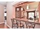 An open kitchen design featuring a breakfast bar with pendant lighting and views into the dining area at 1442 Carlow Cir, Ormond Beach, FL 32174